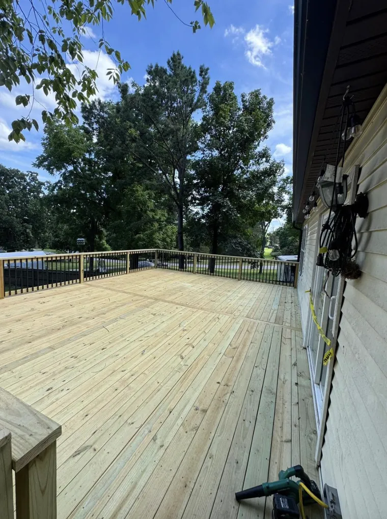 Newly built 20x26 pressure-treated wood deck with black metal balusters near Rogers AR — JHG Contracting LLC