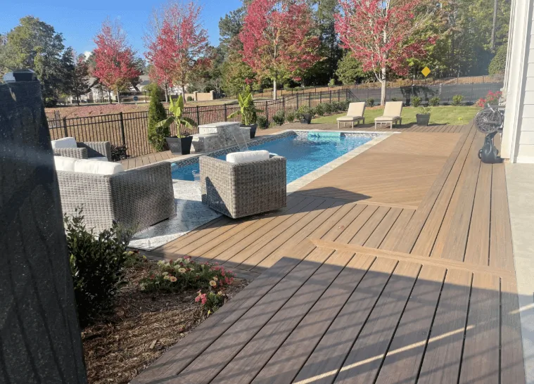 Custom composite deck around pool with lounge furniture NWA Region — JHG Contracting LLC